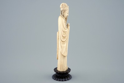 A Chinese carved ivory figure of a sage with a beaker on a lotus-shaped base, 19th C.