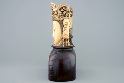 A Chinese carved ivory head of Buddha on wooden stand, 19th C.