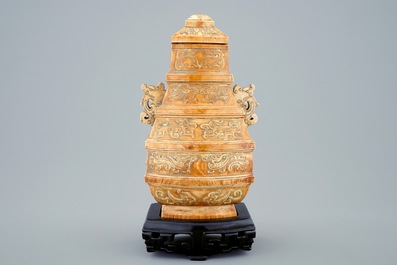 A Chinese parcel-gilt ivory vase and cover on wooden stand, 19th C.