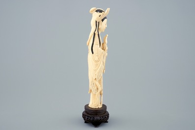 A Chinese carved ivory figure of Guanyin on wooden base, early 20th C.