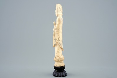 A Chinese carved ivory figure of Guanyin on a wooden base, 19th C.