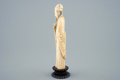 A Chinese carved ivory figure of a sage with a beaker on a lotus-shaped base, 19th C.