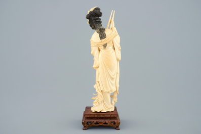 A Chinese carved ivory figure of a lady on wooden base, ca. 1900