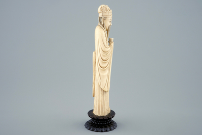 A Chinese carved ivory figure of a sage with a beaker on a lotus-shaped base, 19th C.