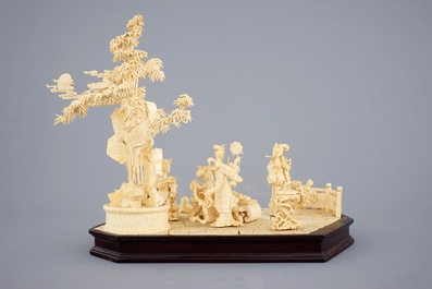 A large Chinese carved ivory group of musicians on a wooden base, early 20th C.