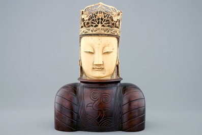 A Chinese carved ivory head of Buddha on wooden stand, 19th C.