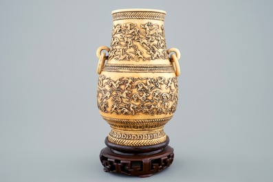 A Chinese carved ivory hu vase on wooden stand, 19th C.