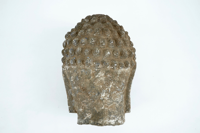 A large carved grey stone head of Buddha, China or Tibet, poss. 16/17th C.