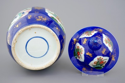 A Chinese famille verte powder blue ground vase and cover, 19th C.