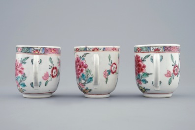 A set of three Chinese famille rose cups and saucers with bords among flowers, Yongzheng/Qianlong