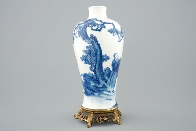 A Chinese blue and white meiping vase on gilt bronze stand, 19th C.