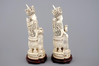 A tall pair of Chinese ivory figures of the emperor couple seated on a throne, ca. 1900