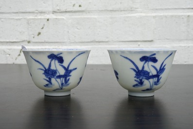 A pair of Chinese blue and white wine cups with 4 floral patterns, six-character mark, Kangxi