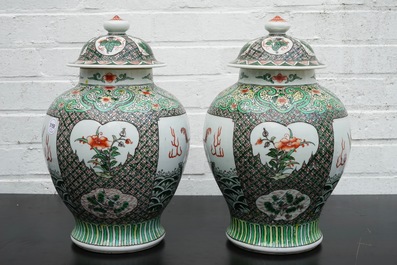 A pair of Chinese famille verte vases and covers with mythical beasts, 19/20th C.