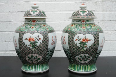 A pair of Chinese famille verte vases and covers with mythical beasts, 19/20th C.