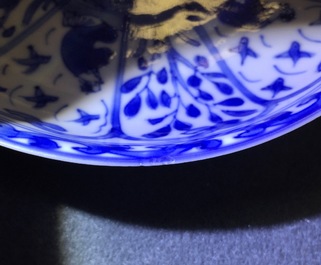 A rare Chinese blue and white Kangxi cup and saucer with French text, Kangxi