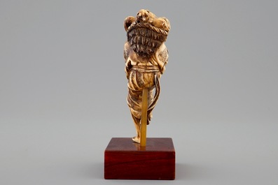 A Japanese ivory okimono of a lady with dogs, Meiji, 19th C.