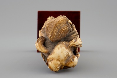 A Japanese ivory okimono of a lady with dogs, Meiji, 19th C.