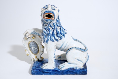 A large Dutch Delft figure of a lion with a coat of arms, 19th C.