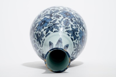 An unusual blue and white Dutch Delft chinoiserie bottle vase with lotus scroll design, late 17th C.