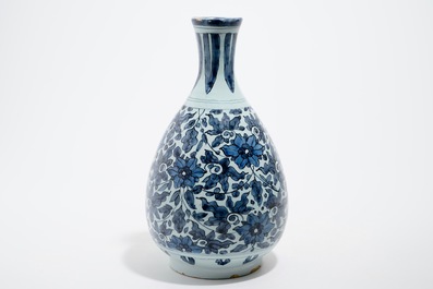 An unusual blue and white Dutch Delft chinoiserie bottle vase with lotus scroll design, late 17th C.