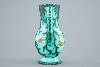A Brussels faience water jug with butterflies and caterpillars, 18/19th C.