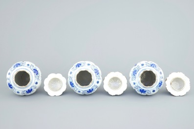 A tall blue and white Dutch Delft five-piece garniture with parrots among foliage, 18th C.