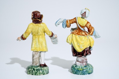 A pair of polychrome figures of newspaper sellers in Dutch Delft style, North of France, 19th C.