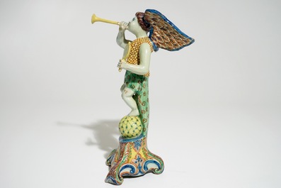 A polychrome Delft style allegorical figure of Fame in the shape of a putto with trumpet, prob. France, 19th C.