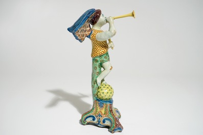 A polychrome Delft style allegorical figure of Fame in the shape of a putto with trumpet, prob. France, 19th C.