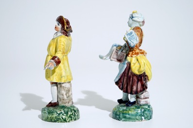 A pair of polychrome figures of newspaper sellers in Dutch Delft style, North of France, 19th C.