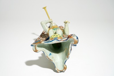 A polychrome Delft style allegorical figure of Fame in the shape of a putto with trumpet, prob. France, 19th C.