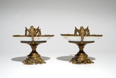 A pair of Chinese bronze-mounted famille rose plates with bats and peaches, Guangxu, 19/20th C.