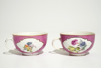 A pair of Meissen ruby ground cups and saucers with floral design, 18th C.