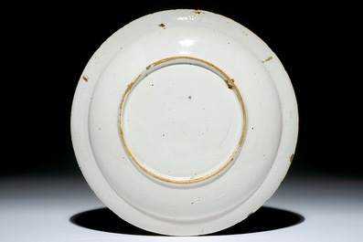 A Dutch Delft plate with cherub heads in an unusual palette, 18th C.