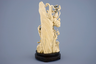A Chinese carved ivory group of the moon goddess and two girls on a wooden base, 19/20th C.