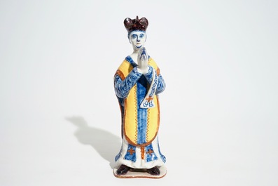 A large Dutch Delft polychrome figure of a standing priest, 18th C.