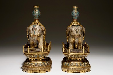 A pair of Chinese gilt bronze and cloisonne elephants on stands, 19th C.