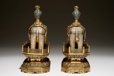 A pair of Chinese gilt bronze and cloisonne elephants on stands, 19th C.