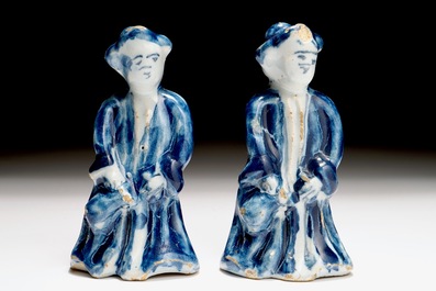 A pair of Dutch Delft blue and white miniatures of men with a jug, 18th C.