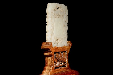 A Chinese white jade plaque with dragons and taoist symbols, 19th C.