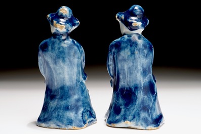 A pair of Dutch Delft blue and white miniatures of men with a jug, 18th C.