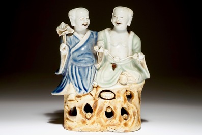 A Chinese celadon and blue-white glazed group of the Hehe Er Xian twins, Qianlong