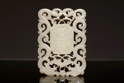 A Chinese white jade plaque with dragons and taoist symbols, 19th C.