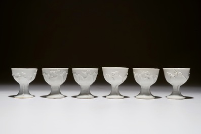 Zes Chinese blanc de Chine stemcups met reli&euml;fdecor, 18/19e eeuw