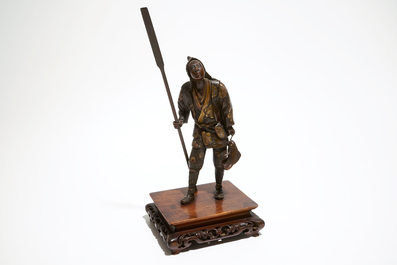 A Japanese bronze figure of a fisherman, signed Miyao, on a wooden stand