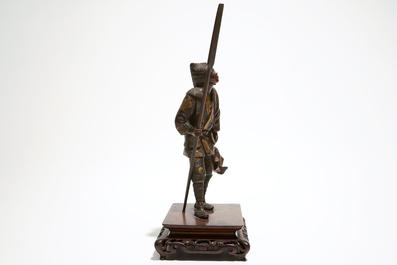 A Japanese bronze figure of a fisherman, signed Miyao, on a wooden stand
