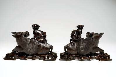 A pair of Chinese ebony carved groups of boys on a buffalo, China, 19th C.
