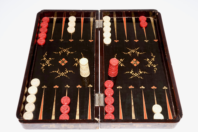 A fine Chinese lacquer chess and backgammon board with ivory game pieces, 19th C.