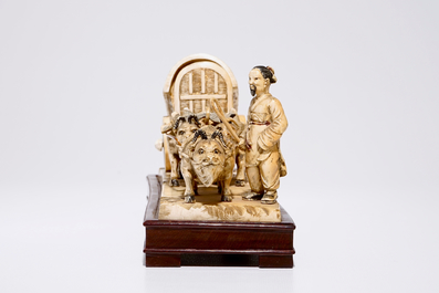 A Chinese carved ivory group of a farmer with buffaloes and a chariot, early 20th C.